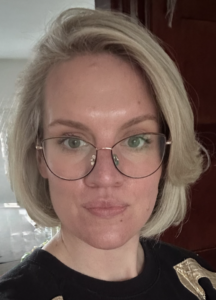 Blond lady with glasses and a black top